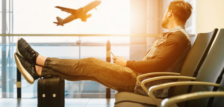 man sitting on chair looking at airplane
